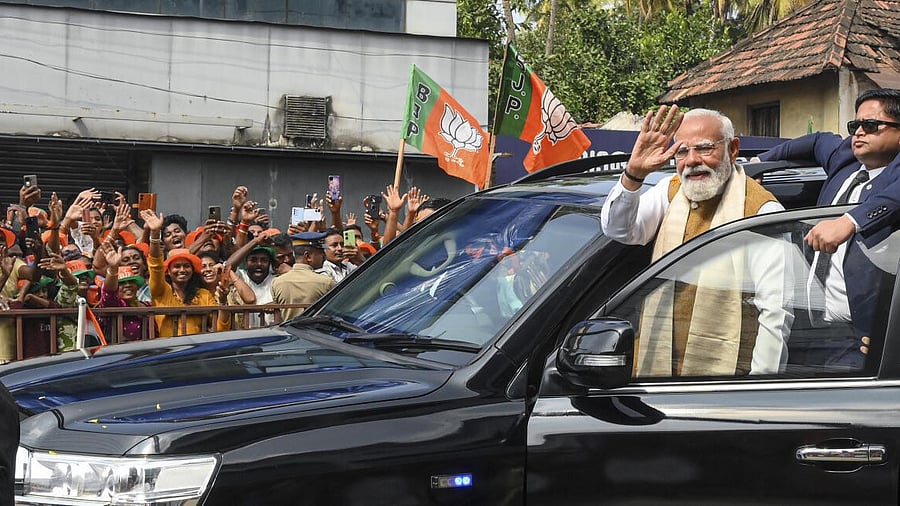 <div class="paragraphs"><p>Prime Minister Narendra Modi waves to the gathering during a roadshow, in Thiruvananthapuram, Kerala</p></div>