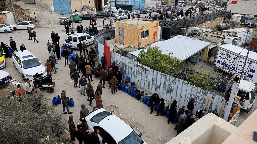 <div class="paragraphs"><p>Palestinians wait in line to refill cooking gas cylinders, amid an ongoing supply shortage in Hebron, in the Israeli-occupied West Bank.</p></div>