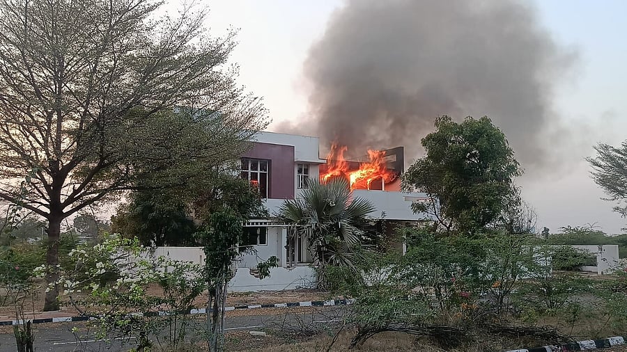 Flames erupt from the model house of MLA G Janardhana Reddy, on the outskirts of Ballari on Friday.