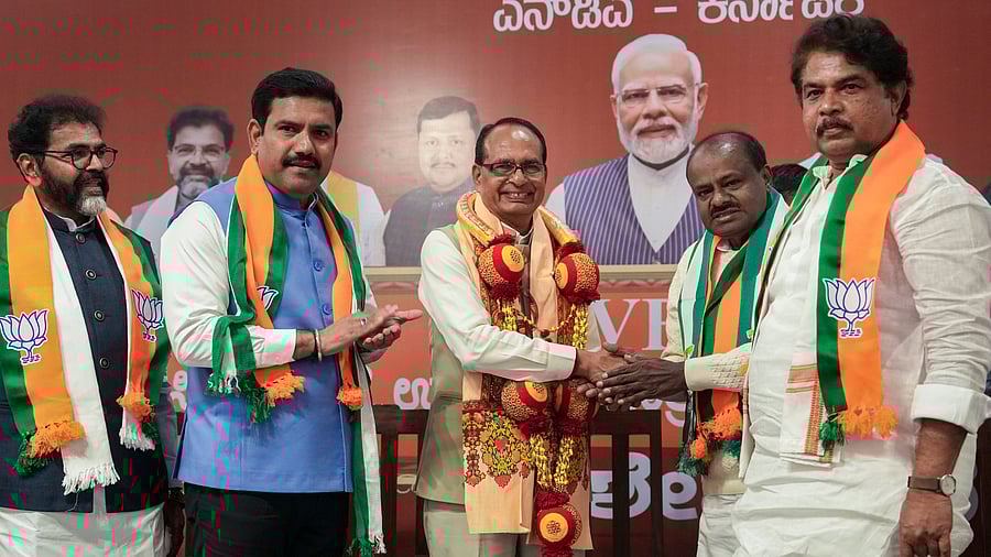 <div class="paragraphs"><p>Union Agriculture Minister Shivraj Singh Chouhan is greeted by Union Minister H D Kumaraswamy at a meeting on VB- G RAM G in Bengaluru on Thursday. BJP leaders Chalavadi Narayanaswamy, B Y Vijayendra and R Ashoka look on. PTI</p></div>