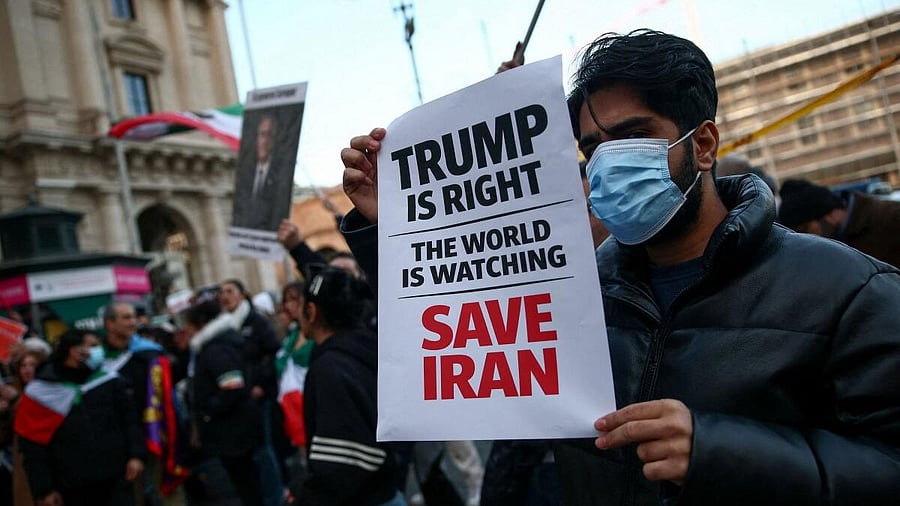 <div class="paragraphs"><p>A man shows a sign mentioning US President Donald Trump during a rally in support of nationwide protests in Iran, in Rome, Italy</p></div>