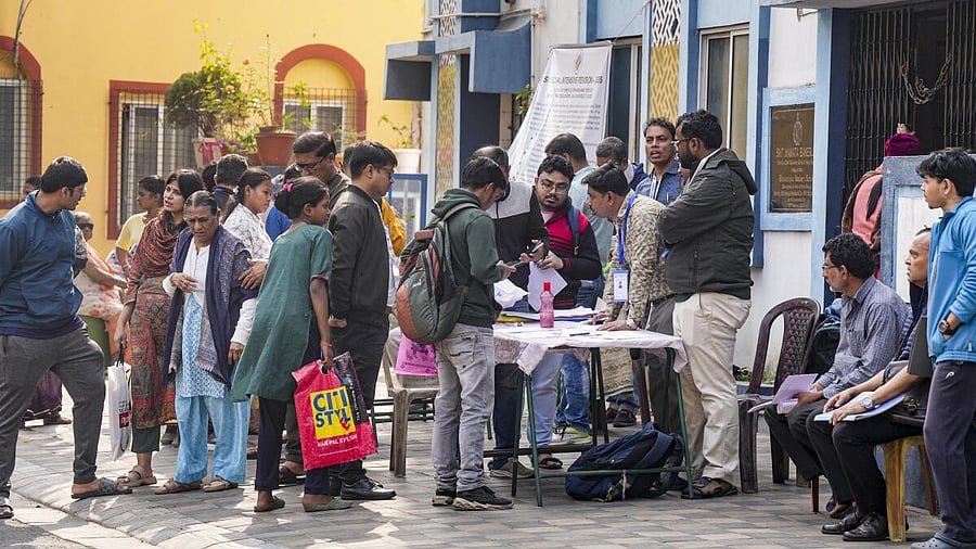 <div class="paragraphs"><p>People gather at a centre during hearings under the Special Intensive Revision (SIR) of the electoral rolls.</p></div>