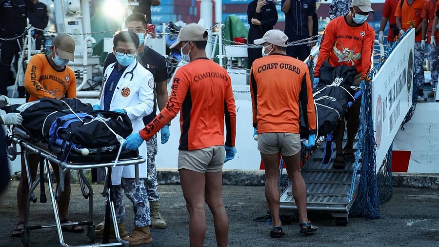 <div class="paragraphs"><p>Philippine Coast Guard personnel carry body bags containing the remains of the crew members who died in the sinking of the cargo ship M/V Devon Bay, at the Port of Manila, Philippines.</p></div>