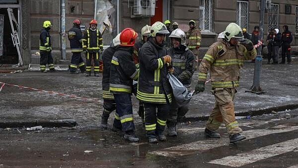 <div class="paragraphs"><p>Rescuers carry a bag with the body of a person found under debris of an apartment building which was hit during Russian drone strikes.</p></div>