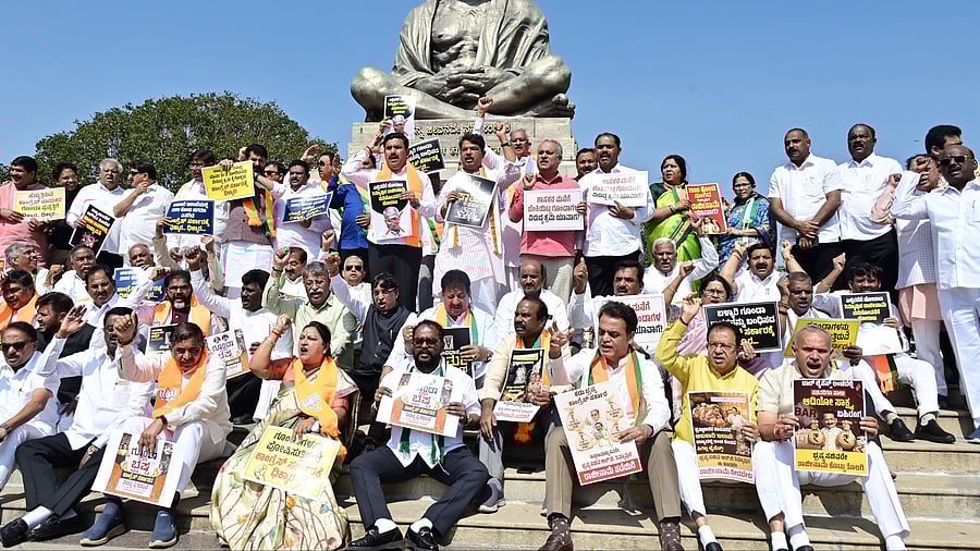 <div class="paragraphs"><p>BJP state president B Y Vijayendra, leader of the Opposition in the Legislative Assembly R Ashoka, leader of the JD(S) legislature party Suresh Babu and other leaders of the two parties stage a protest demanding resignation of Excise Minister R B Thimmapur, in front of the Gandhi statue on the Vidhana Soudha premises on Tuesday.&nbsp;</p></div>
