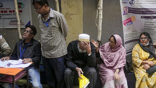 <div class="paragraphs"><p>People with their documents wait for their turn at a centre in central Kolkata during hearings under the Special Intensive Revision (SIR) of the electoral rolls.</p></div>