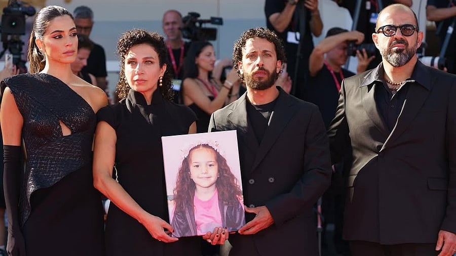 <div class="paragraphs"><p>The team of ‘The Voice of Hind Rajab’&nbsp;at the 82nd Venice International Film Festival, with the photo of six-year-old Hind Rajab, who was killed by the Israel Defense Forces in Gaza. The film is nominated for Best International feature at the Academy awards. </p></div>