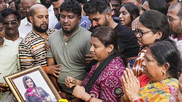 <div class="paragraphs"><p>Bereaved family members pay their last respects to the mortal remains of flight attendant Pinky Mali, who was killed in the Baramati plane crash that also claimed the life of Maharashtra Deputy Chief Minister Ajit Pawar, during her funeral, in Mumbai.</p></div>