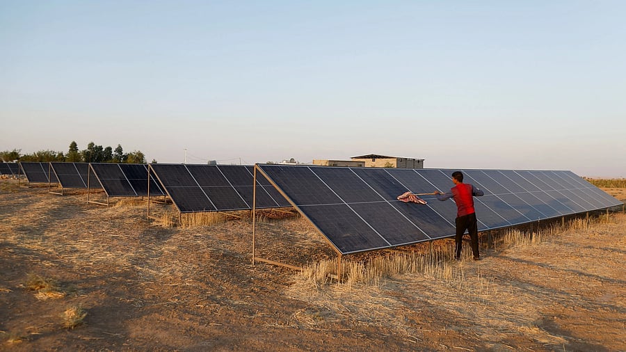 <div class="paragraphs"><p>A worker cleans solar panels, a sustainable energy option</p></div>