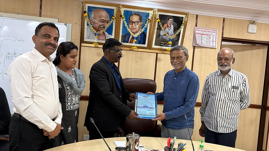 <div class="paragraphs"><p>BDA Commissioner Major Manivannan symbolically exchanges property records and compensation papers with landowners. </p></div>