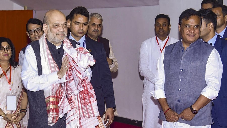 <div class="paragraphs"><p>Union Home Minister Amit Shah greets as he arrives at the BJP office, Vajpayee Bhawan, in Guwahati.</p></div>
