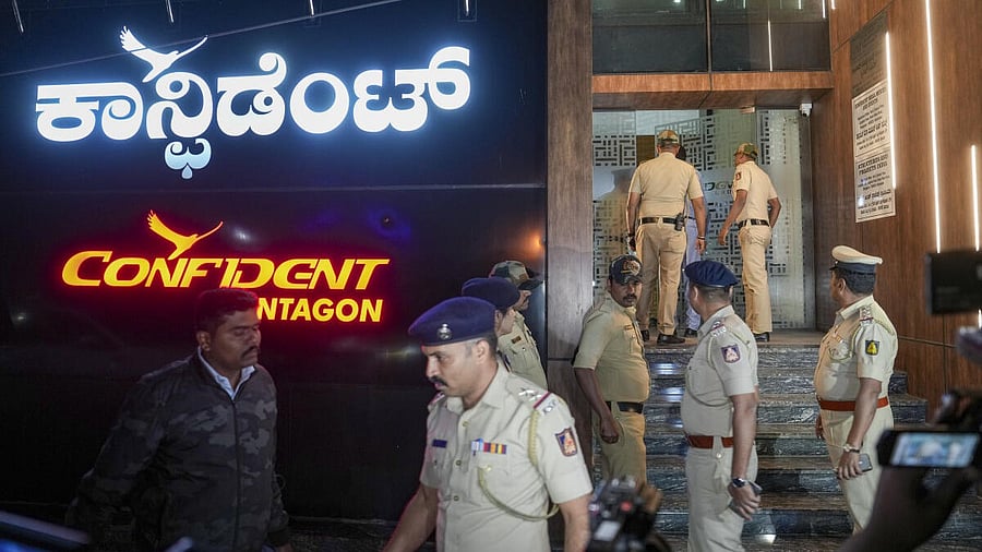 <div class="paragraphs"><p>Police personnel stand guard outside Confident Group’s office building</p></div>