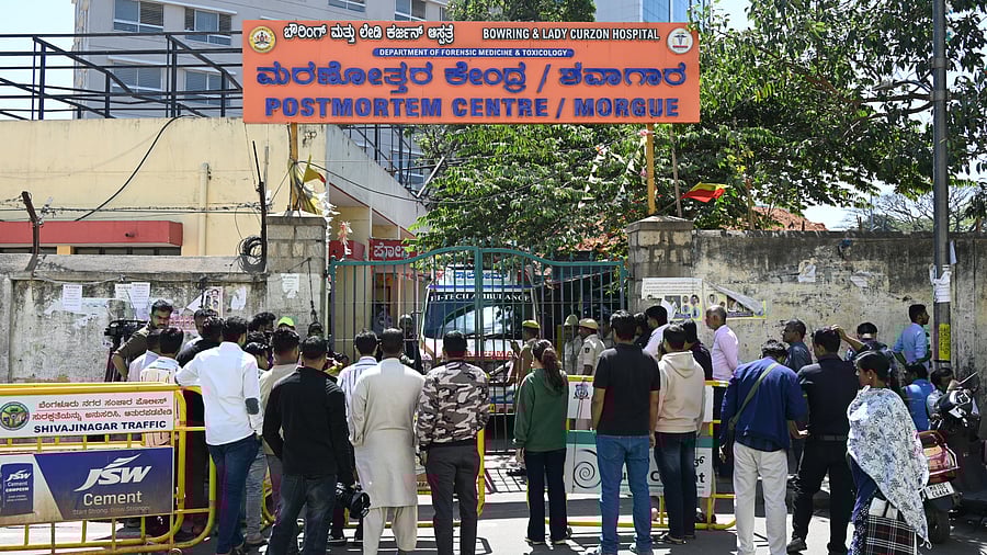 <div class="paragraphs"><p>People gather outside Bowring Hospital in Bengaluru, where the post mortem of C J Roy’s body was conducted, in Bengaluru on Saturday. </p></div>