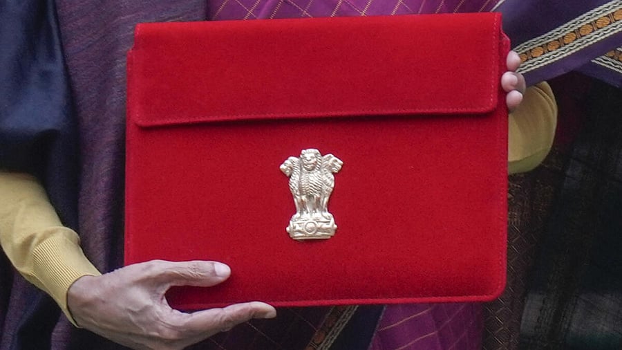 <div class="paragraphs"><p>Finance Minister Nirmala Sitharaman shows the digital tablet, enclosed in a traditional red 'bahi-khata' style pouch, at the Parliament premises before presenting of the ‘Union Budget 2026-27’.</p></div>