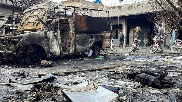 <div class="paragraphs"><p>People walk amid damages at a police station, following militant attacks, in Quetta, Pakistan.</p></div>