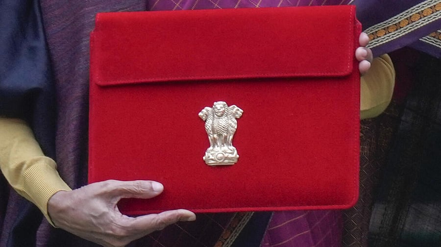 <div class="paragraphs"><p>Finance Minister Nirmala Sitharaman shows the digital tablet, enclosed in a traditional red 'bahi-khata' style pouch, at the Parliament premises</p></div>