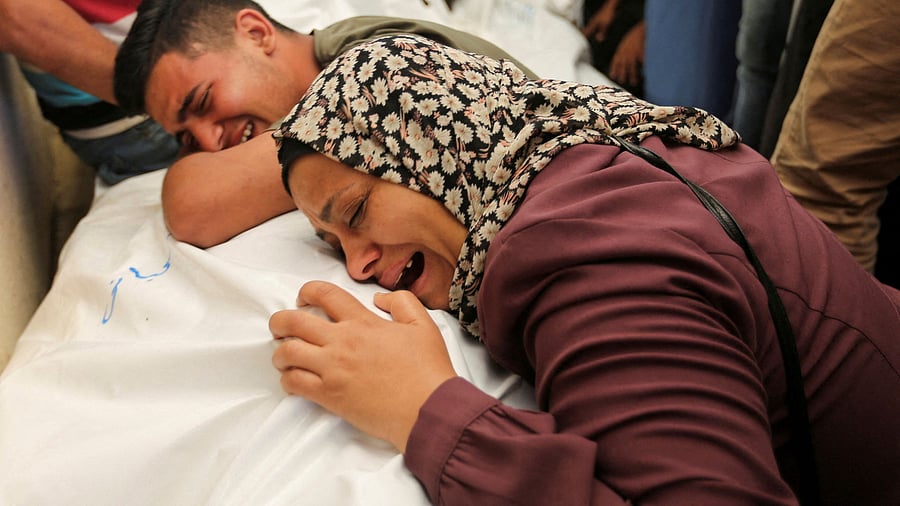 <div class="paragraphs"><p>Mourners react next to the bodies of Palestinians, killed in Israeli strikes.(Representative image)</p></div>