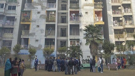 <div class="paragraphs"><p>People gather after three minor sisters allegedly jumped off the balcony of a ninth-floor flat and died, in Ghaziabad.</p></div>