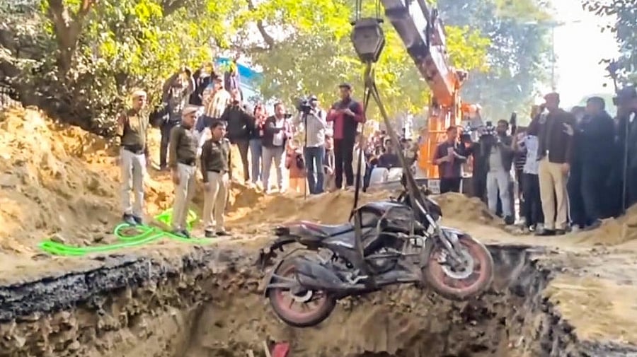 <div class="paragraphs"><p>The bike of a motorcyclist who plunged into an uncovered pit dug for construction work by Delhi Jal Board, being lifted out, at Janakpuri, in New Delhi.</p></div>