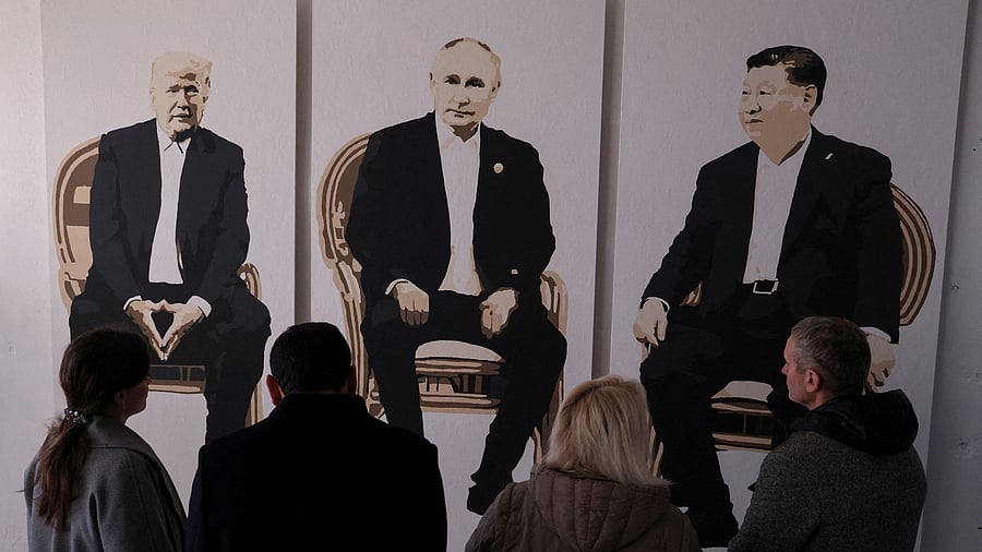 <div class="paragraphs"><p>Visitors stand in front of an artwork depicting US President Donald Trump, Russian President Vladimir Putin and Chinese President Xi Jinping </p></div>