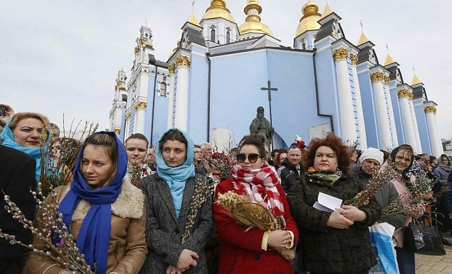 Believers gather outside the St. Michael's Golden-Domed Cathedral as they mark the Palm Sunday in Kiev, Ukraine. Reuters Photo