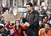 Thousands of protesting Indian students hold up placards at a rally in Melbourne on Sunday. AFP
