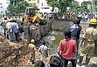 Still no luck: Firemen searching for the body of Abhishek, who was washed away in an overflowing drain in Lingarajapuram. DH PHOTO