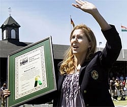 International Tennis Hall of Fame inductee Monica Seles waves to the crowd as she holds her plaque during ceremonies in Newport, R.I. Saturday, AP