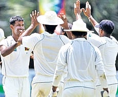 Nuwan Kulasekara is congratulated by his Sri Lankan team-mates at the P Sara Oval on Sunday. AP