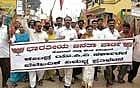 UP IN ARMS Members of BJP district unit taking out a protest march condemning rise in the price of essential commodities in Kolar on Monday. DH Photo