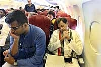 Minister of State for External Affairs Shashi Tharoor takes a nap while traveling in an economy class flight. IANS