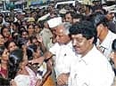 CM B S Yeddyurappa listening to the grievances of Krishnananda Nagar residents during his visit to the rain-hit areas in the City, Friday. Dh Photo