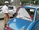 An iron rod fell from the metro rail bridge piercing the windshield of a Reva car on MG Road in Bangalore on Monday. DH Photo