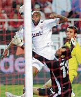 Well beaten: Sevillas Frederic Kanoute (left) scores past Villarreal goalkeeper Xavi Oliva in the Spanish league. AFP