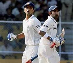 Gautam Gambhir and Rahul Dravid cross for a run on the fourth day of the first match between India and Sri Lanka at the Motera Stadium in Ahmedabad.PTI