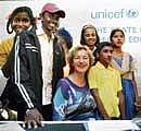 Unicef representative Karin Hulshof with children at the release of 'The State of World's Children' in New Delhi on Friday. PTI