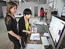 Dany Levy, DailyCandys Founder and Editorial Director, (left) & Eve Epstein choosing items to photograph for a sample sale.