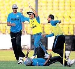 Indias Virender Sehwag (centre) celebrates with team-mates after scoring a goal during a practice session on Tuesday at Nagpur. AFP