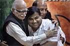 Bharatiya Janata Party's veteran party leader L K Advani, left, hugs newly appointed party president Nitin Gadkari, on Saturday. AP .