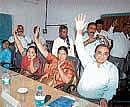 Virajpet Town Panchayat members M K Poovaiah, Maria Sequeira, Tara raising their hands during no-confidence motion against President K Kanthi Belliappa. DH photo