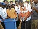Law Minister Suresh Kumar leading by example during the 'Keep City Clean - Keep Diseases Away' awareness programme in Rajaji Nagar on Saturday. DH PHOTO