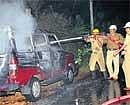 Fumes of anger: Fire personnel putting out fire after a mob torched a van at Uttarahalli in Bangalore on Wednesday. DH Photo