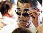 President Barack Obama looks over his sunglasses in Kailua, Hawaii, on Friday. AP