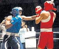 Power-packed: Karnatakas Rojit Kumar (left) lands a left on Andaman & Nicobars Thyagarajan in the South Zone boxing championship in Bangalore on Monday. DH Photo
