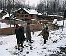 Children play with snow in the outskirts of Anantnag, 48 kms from South Kashmir in Srinagar on Tuesday. PTI Photo
