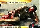 A TV grab: Policeman R Vetrivel, in Tamil Nadu lies on the road begging for help after the 44-year-old's leg have been chopped off by gangsterson Thursday. AP