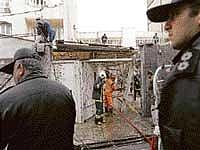 Iranian security guards, firemen and municipality workers at the scene of a bomb explosion in which an Iranian university lecturer was killed, in Tehran on Tuesday. AFP