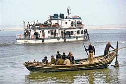 Securitymen keep vigil near a floating restaurant in the river Ganga where Bihar Chief Minister Nitish Kumar held a cabinet meeting in Patna on Thursday. Pti