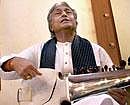 Ustad Amjad Ali Khan displaying his damaged sarod during a show in Mumbai on Thursday night. PTI