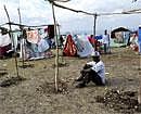 Handout photo provided on January 20, 2010 by Medecins Sans Frontieres (Doctors Without Borders) shows a man sitting in an available empty space at the makeshift camp in Jacmel, Haiti, on Tuesday. AFP